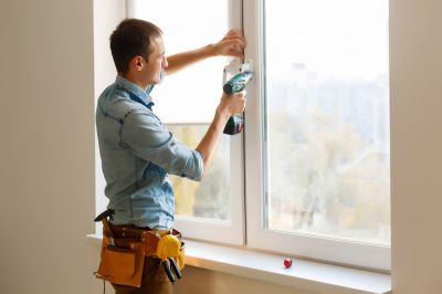 Handyman Repairing a Window